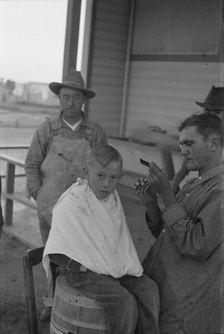 Community barber shop in Kern County migrant camp, California, 1936. Creator: Dorothea Lange