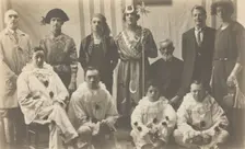 Concert party performers, some in drag, pose for a group portrait, (between 1910 and 1919?). Creator: Unknown