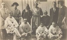 Concert party performers, some in drag, pose for a group portrait, (between 1910 and 1919?). Creator: Unknown