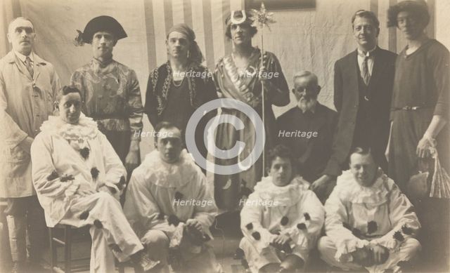 Concert party performers, some in drag, pose for a group portrait, (between 1910 and 1919?). Creator: Unknown.