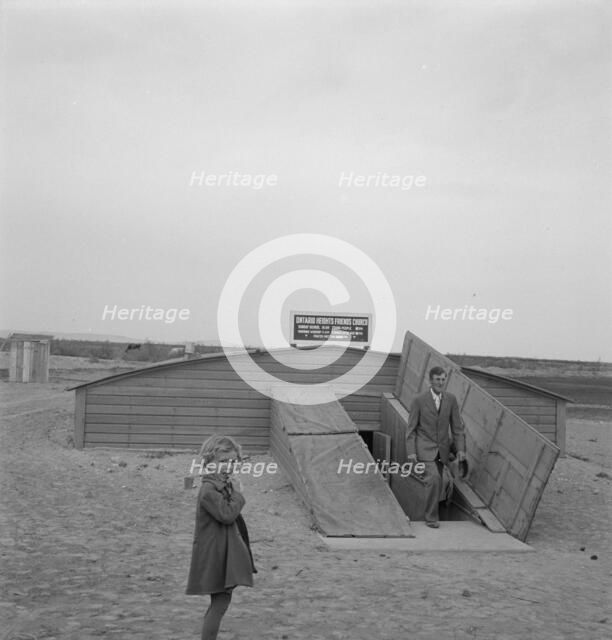 Congregation leaving after services, Dead Ox Flat, Oregon, 1939. Creator: Dorothea Lange.