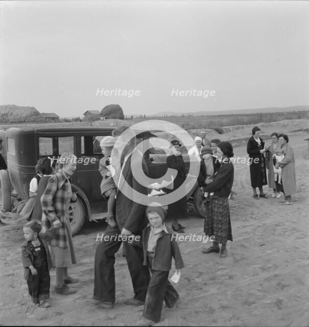 Congregation leaving after services, preacher in doorway, Dead Ox Flat, Oregon, 1939. Creator: Dorothea Lange.