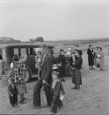 Congregation leaving after services, preacher in doorway, Dead Ox Flat, Oregon, 1939. Creator: Dorothea Lange