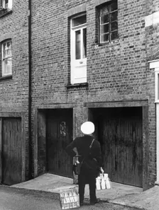 Confused milkman confronted with a doorstep on the first floor, c1955. Creator: Arthur Charles Kirby Ware