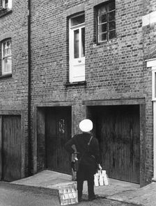 Confused milkman confronted with a doorstep on the first floor, c1955. Creator: Arthur Charles Kirby Ware