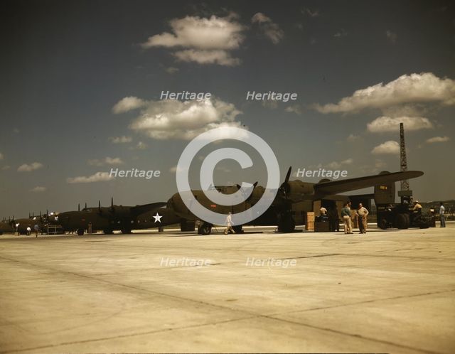 Consolidated transport planes being loaded, Consolidated Aircraft Corp., Fort Worth, Texas, 1942. Creator: Howard Hollem.