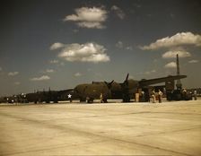 Consolidated transport planes being loaded, Consolidated Aircraft Corp., Fort Worth, Texas, 1942. Creator: Howard Hollem