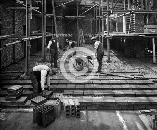 Construction workers laying a hollow pot floor, 8 Lloyds Avenue, City of London, 1907. Artist: Bedford Lemere and Company.