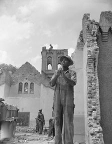 Construction workman wrecking a church on Independence Avenue, Washington, D.C, 1942. Creator: Gordon Parks