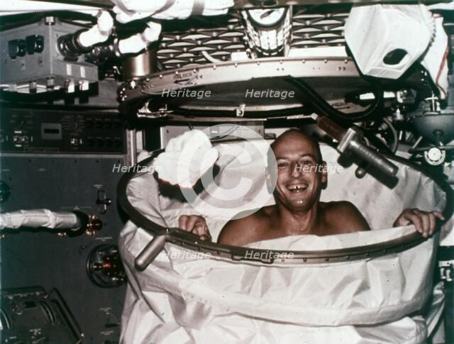 Conrad in shower facility aboard Skylab 2, 1973. Creator: NASA.
