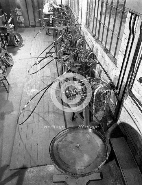 Continuous sharpening of longsaw blades, Slack Sellars & Co, Sheffield, South Yorkshire, 1963.  Creator: Michael Walters.
