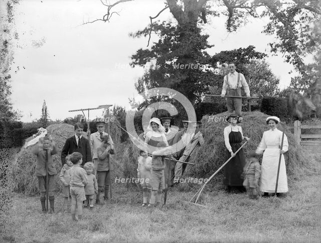 Convalescent soldiers helping women and children with haymaking, Great Dixter, East Sussex, 1916. Artist: Nathaniel Lloyd