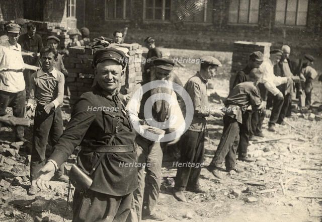 Conveyor system for transferring bricks: Cleanup day at Traktorostroye, Kharkiv, 1920-1929. Creator: Unknown.