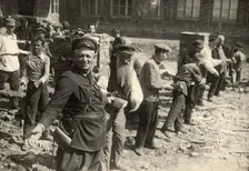Conveyor system for transferring bricks: Cleanup day at Traktorostroye, Kharkiv, 1920-1929. Creator: Unknown