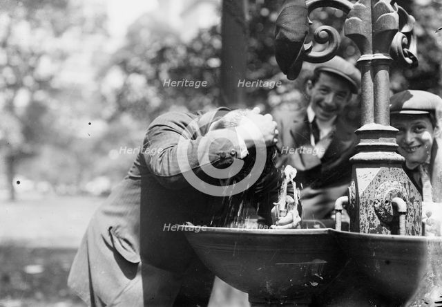 Cooling his head - N.Y. on hot day, between c1910 and c1915. Creator: Bain News Service.