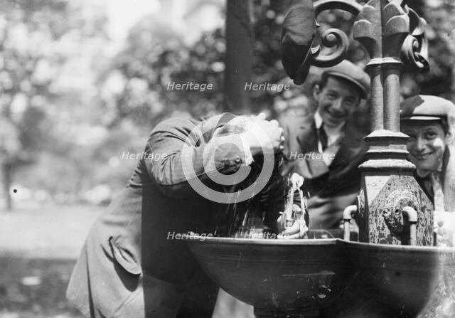 Cooling his head - N.Y. on hot day, between c1910 and c1915. Creator: Bain News Service.