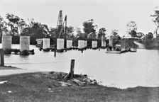Coomera River Ferry and construction of the road bridge, 1929. Creator: Jack Bain