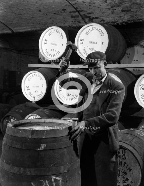 Coopering, making whiskey barrels at Wiley & Co, Sheffield, South Yorkshire, 1961.  Creator: Michael Walters.