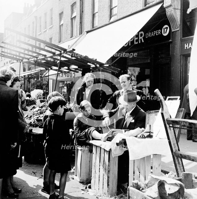 Corn Cure, Chapel Street Market, Islington, London, 1955. Creator: Henry Grant.