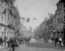 Cornmarket Street decorated with flags and banners for a royal visit, Oxford, Oxfordshire, 1897. Creator: Henry Taunt
