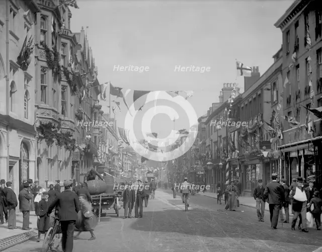 Cornmarket Street decorated with flags and banners for a royal visit, Oxford, Oxfordshire, 1897.  Creator: Henry Taunt.