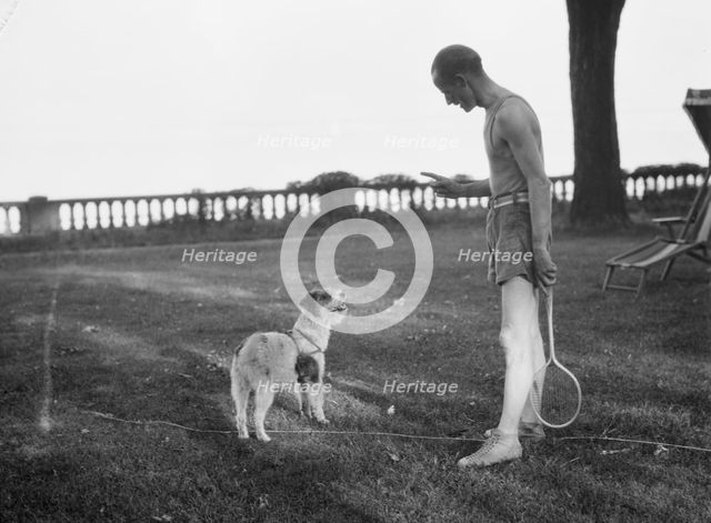 Cosgrave, Mr., with dog, outdoors, not before 1917. Creator: Arnold Genthe.
