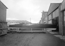 Cabin cruiser D.G.S.I. on stand at boatyard, 1913. Creator: Kirk & Sons of Cowes