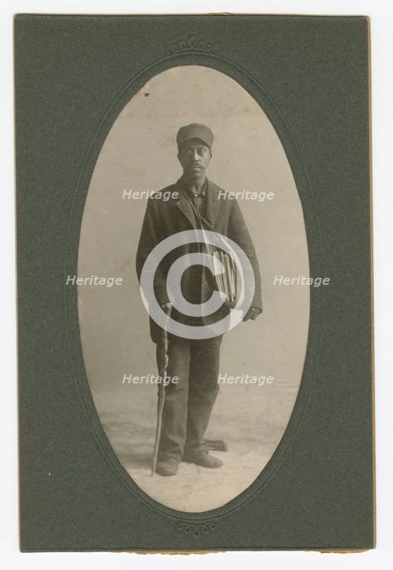 Cabinet card of a newspaper carrier, mid to late 19th century. Creator: Unknown.