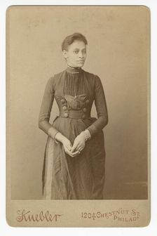 Cabinet card of a woman, 1885-1892. Creator: William J. Kuebler