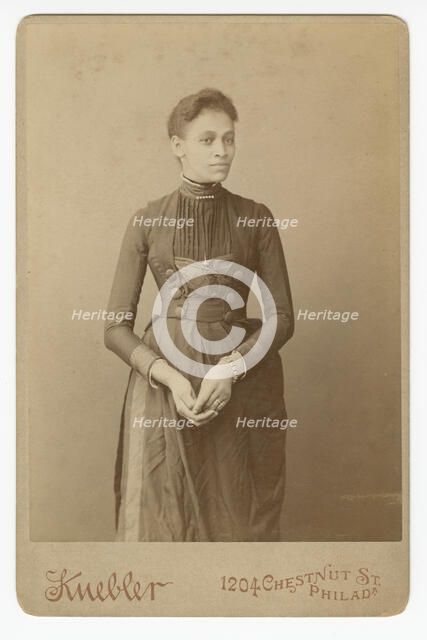 Cabinet card of a woman, 1885-1892. Creator: William J. Kuebler.