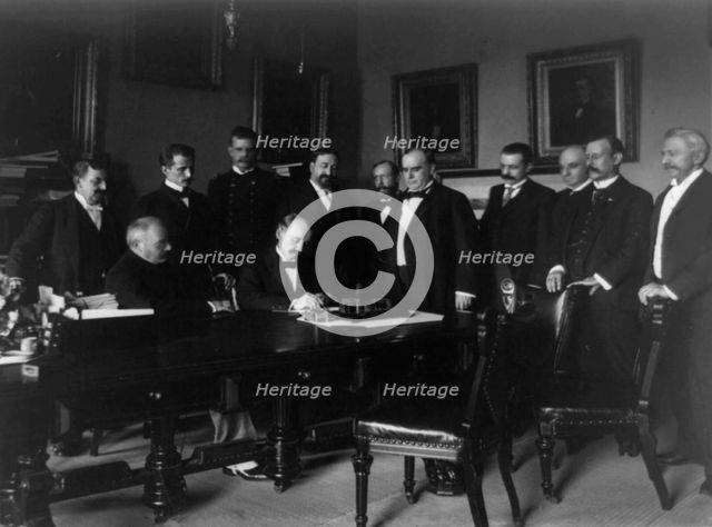 Cabinet Room, White House, Aug. 12, 1898. Secy. of State William R. Day signing, c1898. Creator: Frances Benjamin Johnston.