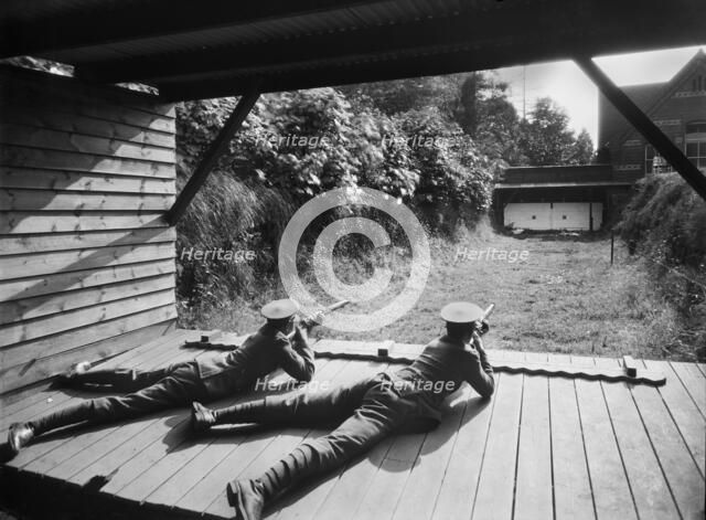 Cadets in the Officer Training Corps using the rifle range, Reading School, Berkshire, 1920-1939. Artist: Marshall Keene and Company.
