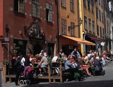 Café and colourful houses, Stortorget Square, Stockholm, Sweden. Creator: Peter Thompson