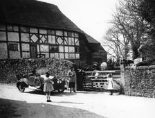 Calcott 2-seater car parked outside a farm gate, c1921-c1922