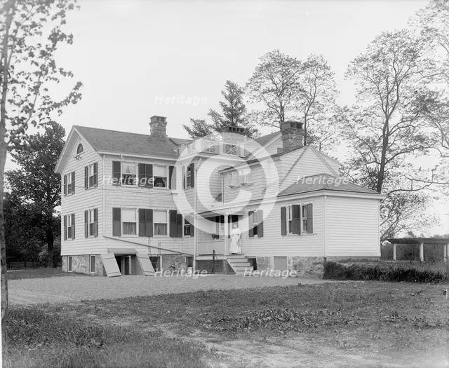 Calloway residence, back, showing porch with woman, Mamaroneck, N.Y., between 1900 and 1915. Creator: William H. Jackson.