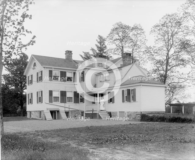 Calloway residence, back, showing porch with woman, Mamaroneck, N.Y., between 1900 and 1915. Creator: William H. Jackson.