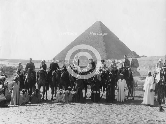 Camel tour in front of one of the Pyramids of Giza, Egypt, c1920s-c1930s(?). Artist: Unknown