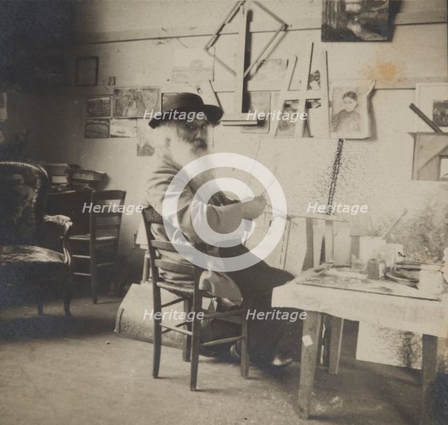Camille Pissarro painting in his studio, c1860-1903. Creator: Unknown.