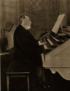 Camille Saint-Saëns (1835-1921) at the Organ, 1913. Creator: Anonymous