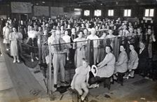 Camouflage net making, Kelvin Grove Drill Hall (now Z 10), Brisbane, 1941. Creator: Isabel Bain
