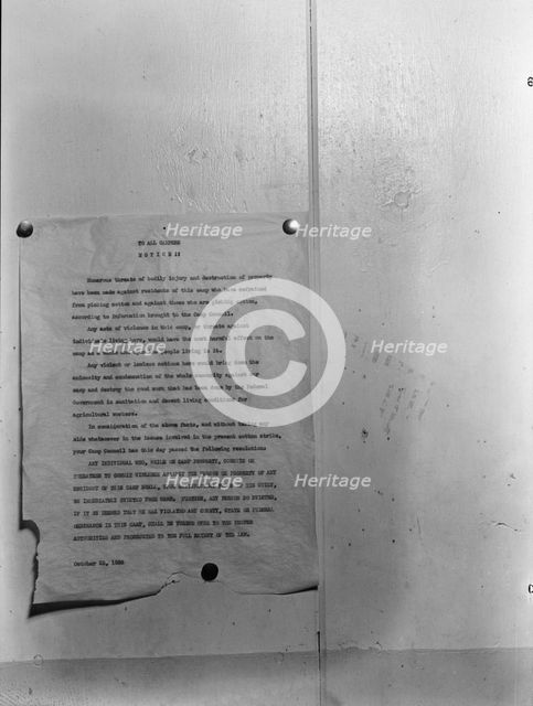 Camp bulletin board in Shafter camp for migratory workers, FSA camp, California, 1938. Creator: Dorothea Lange.