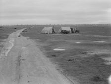 Camp of two related families seen from U.S. 99., Kern County, California, 1939. Creator: Dorothea Lange