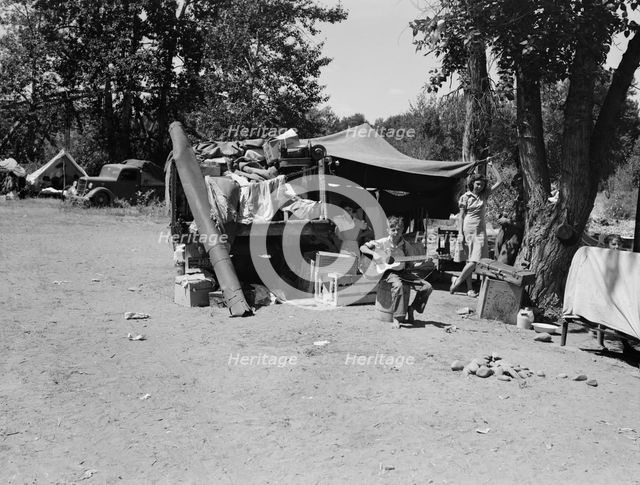 Camp of family with nine children...on the road for three years, Washington, Yakima Valley, 1939. Creator: Dorothea Lange.