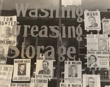 Campaign posters in garage window, just before the primary. Waco, Texas, 1938-06. Creator: Dorothea Lange