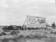 Camped in the rain behind billboard...on U.S. 99, near Famosa, Kern County, California, 1939. Creator: Dorothea Lange