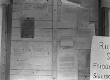Campers bulletin board at Shafter camp, California, 1938. Creator: Dorothea Lange