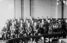 Candidates for naturalization seated in room, hats in laps, 1916. Creator: Bain News Service