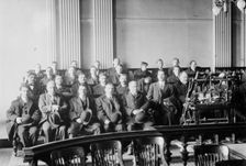 Candidates for naturalization seated in room, hats in laps, 1916. Creator: Bain News Service