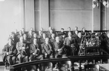Candidates for naturalization seated in room, hats in laps, 1916. Creator: Bain News Service