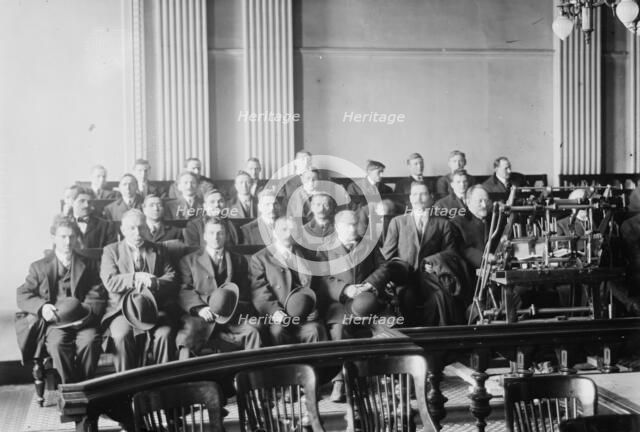 Candidates for naturalization seated in room, hats in laps, 1916. Creator: Bain News Service.